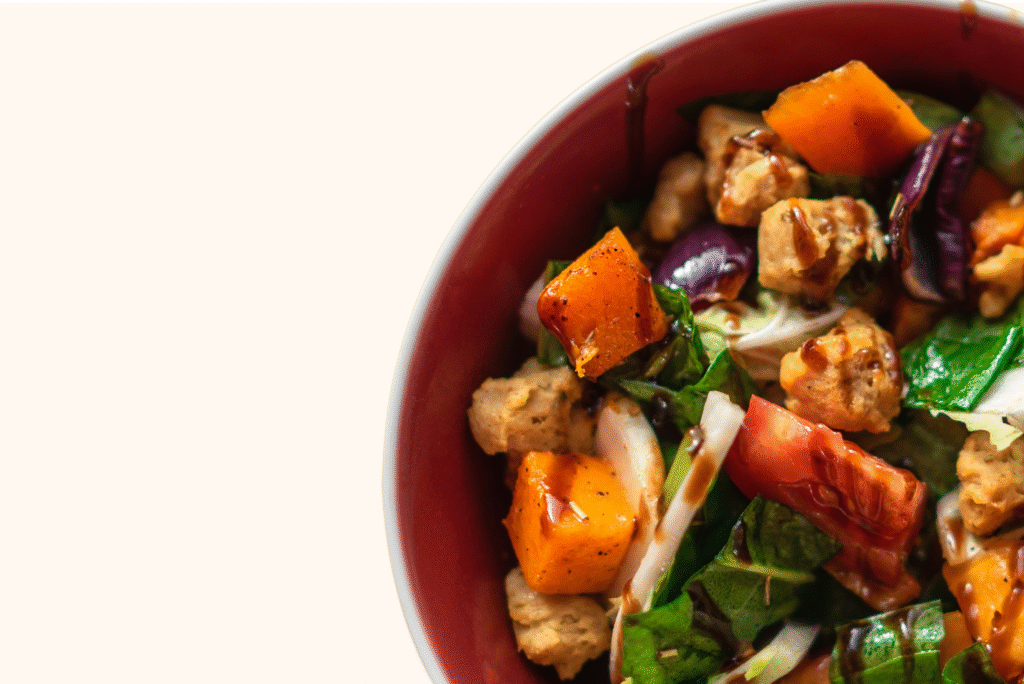 Close-up of a vibrant harvest bowl filled with roasted vegetables, fresh greens, and colorful toppings, embodying Cook Forth’s spirit of creativity, courage, and community in every meal.